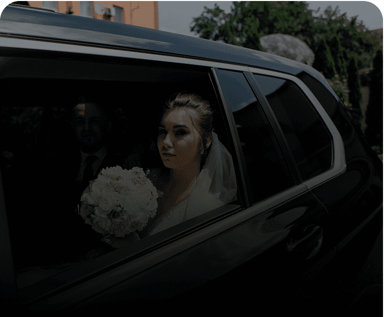Woman in wedding dress in vehicle