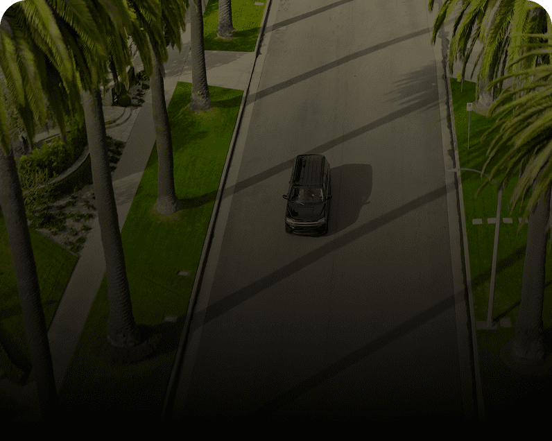 Black vehicle driving on sunny road