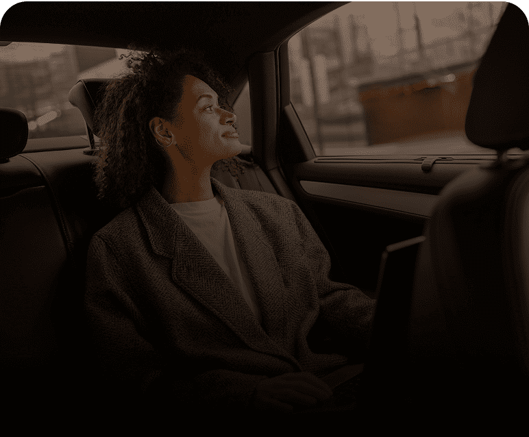 Person daydreaming in backseat of car