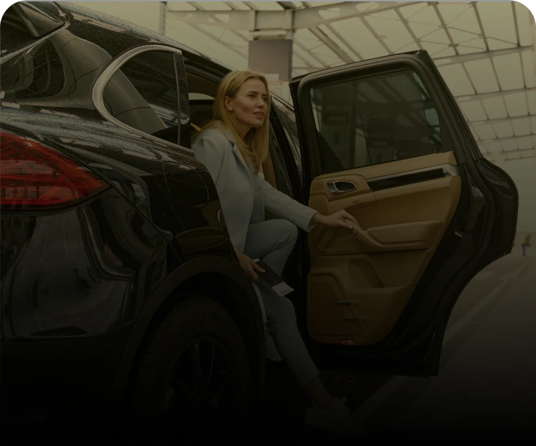 Woman exiting a black car